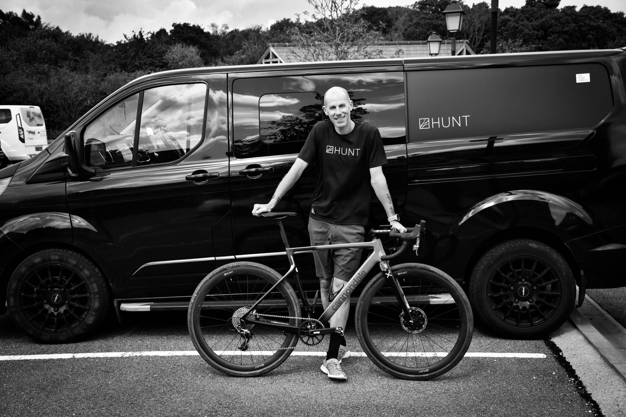 Simon with his bike in front of HUNT van