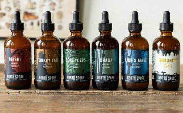 Bottles of herbal extracts on a wooden surface.