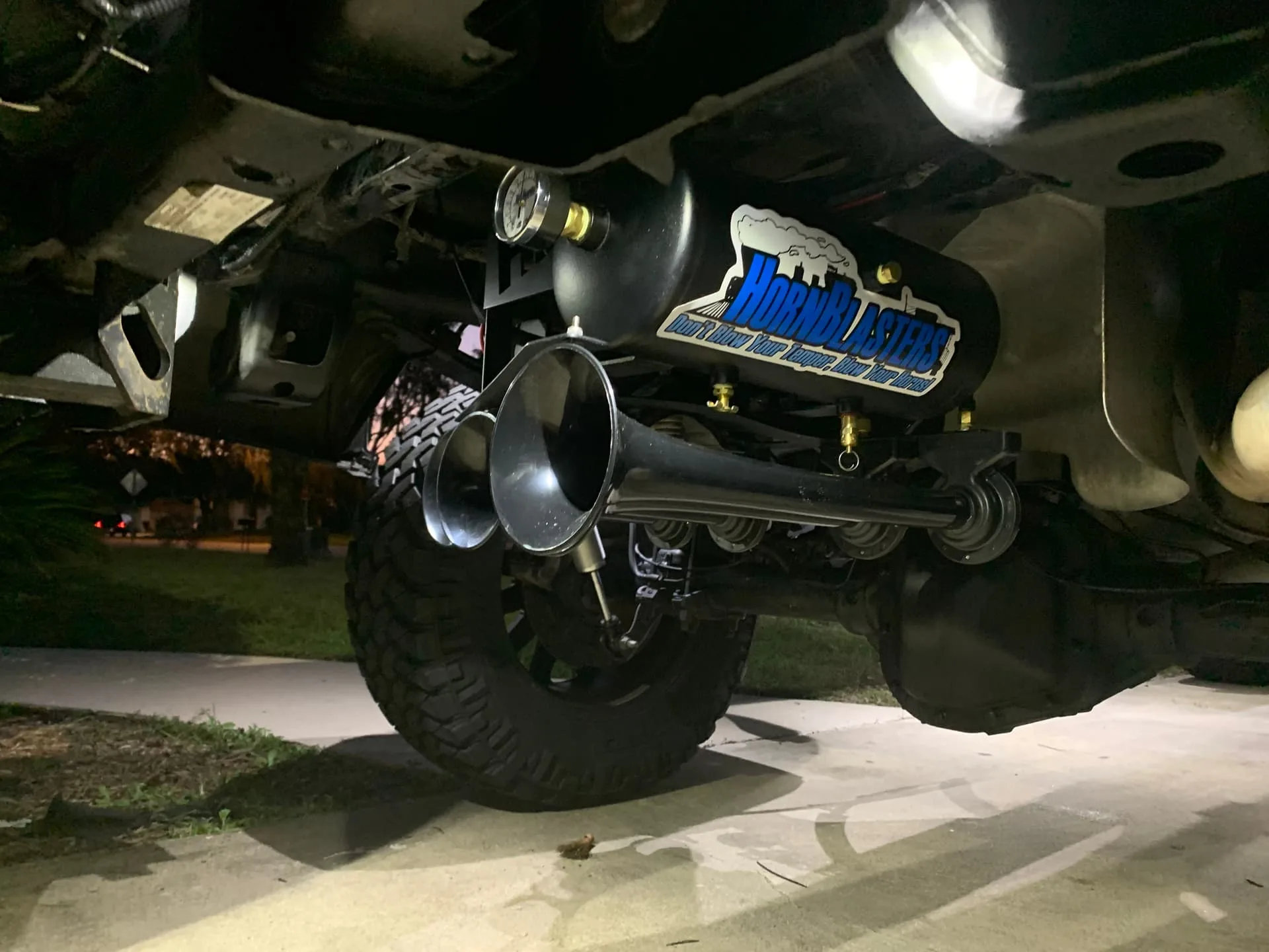 Wide underside view of HornBlasters train horn kit on lifted truck