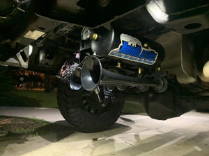 Wide underside view of HornBlasters train horn kit on lifted truck