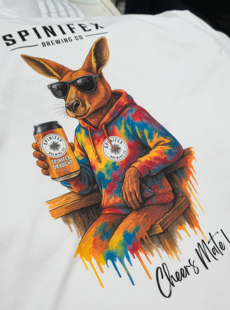 White t-shirt with kangaroo illustration wearing sunglasses and holding a drink, printed in bright dripping paint style.
