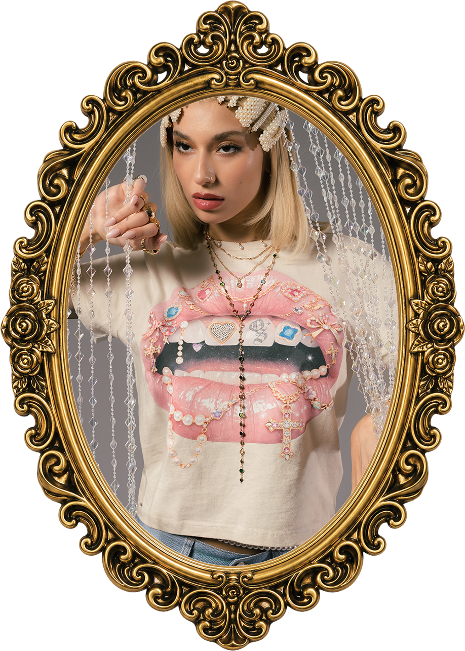 Person in ornate frame wearing a graphic t-shirt and jewelry.
