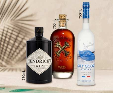 Three bottles of alcohol: Hendrick's gin, rum, and Grey Goose vodka.