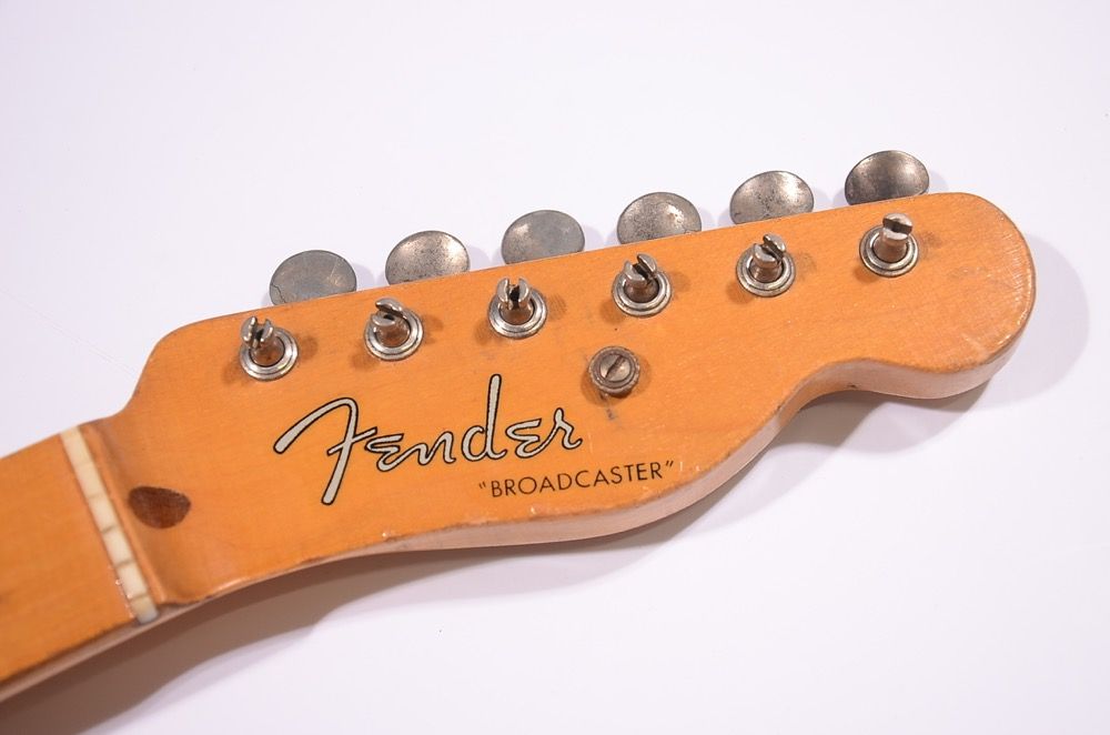 Fender guitar headstock with tuning pegs and logo.