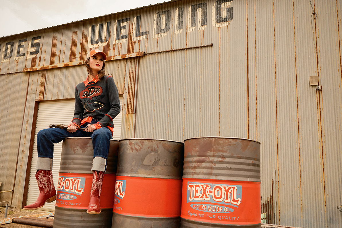 Kaylin wearing the Fueled by Fashion Tee with the Jake shirt, and Spaghetti Western Boots.