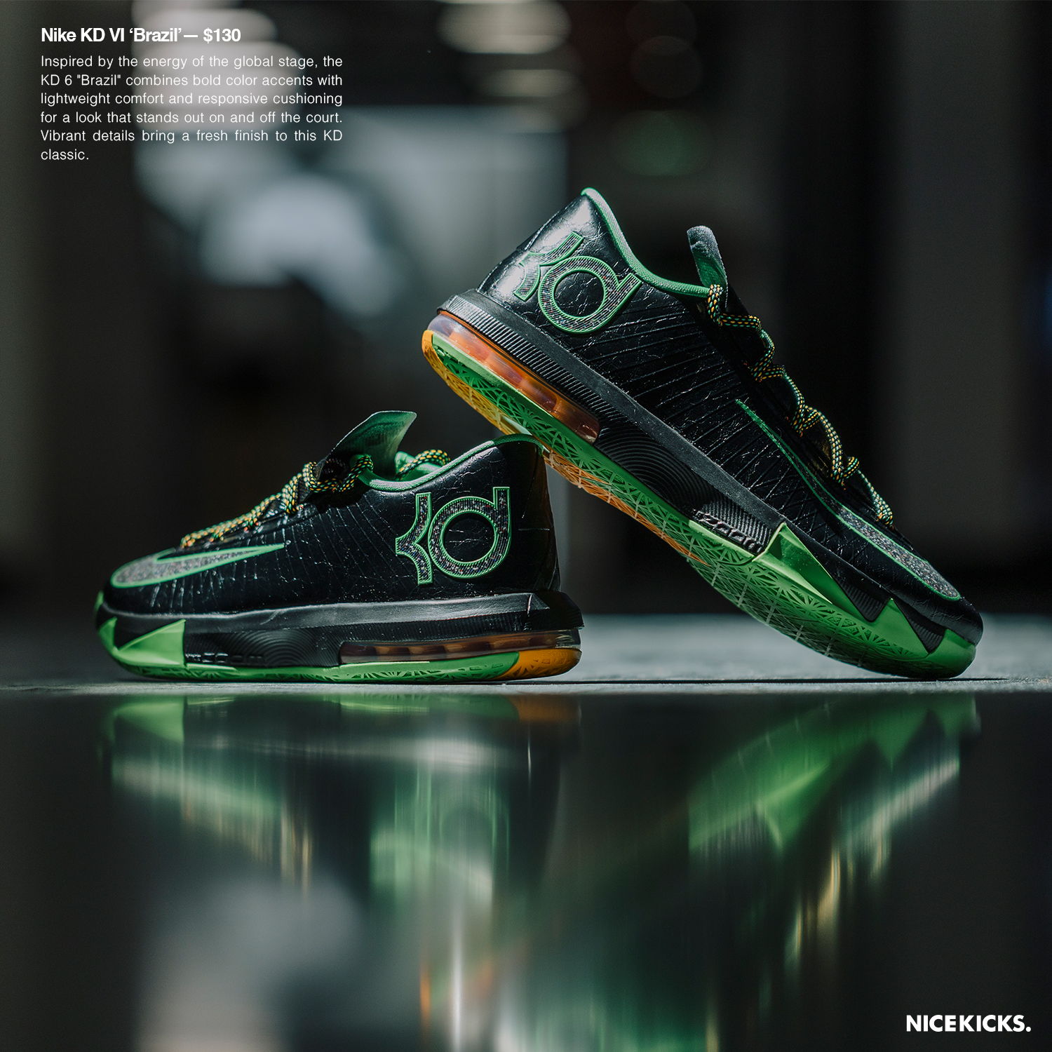 Black and green basketball shoes displayed on a reflective surface.