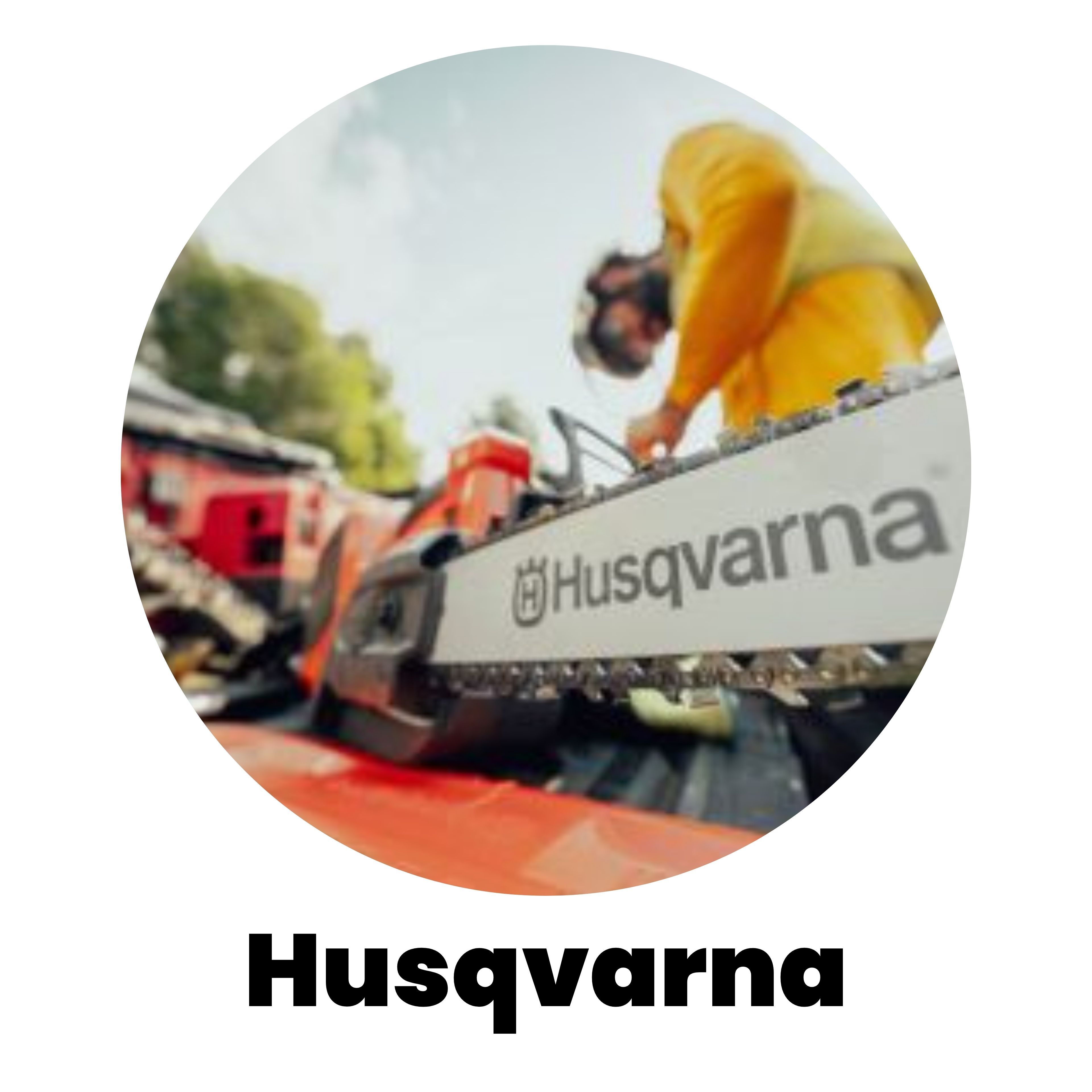 Person using a Husqvarna chainsaw in a forested area.