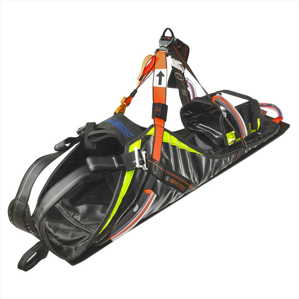 Black and yellow rescue sled with harness and safety straps.