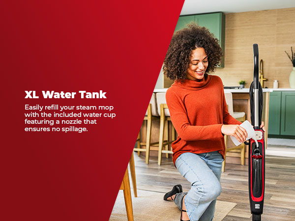 A woman refilling a steam mop's water tank in a modern kitchen. Text about XL water tank.