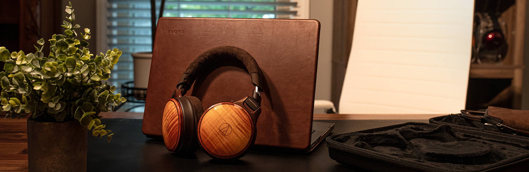 WB2022 Headphones with a laptop on a table