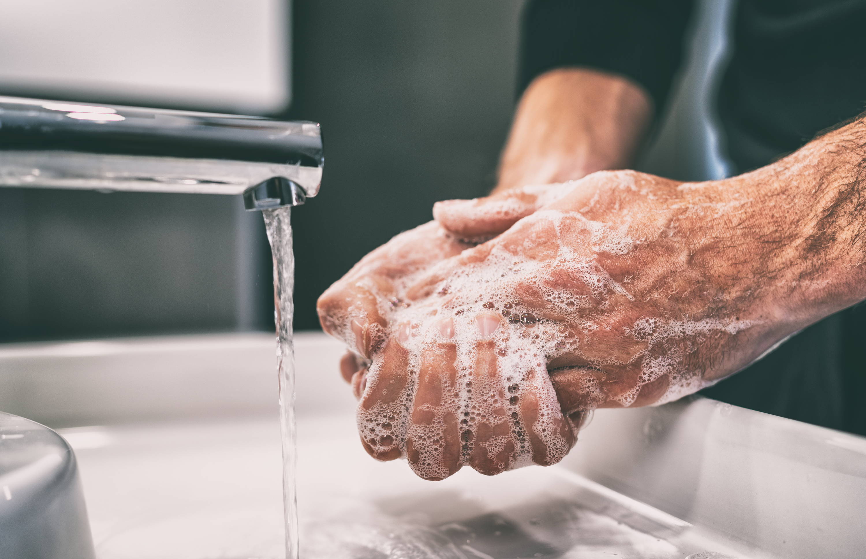 Hygiene. Person washing their hands. Washing hands with soap. 