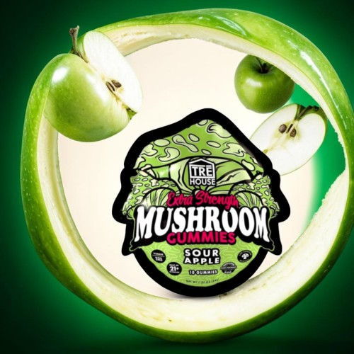 Sour apple mushroom gummies with green apple background.