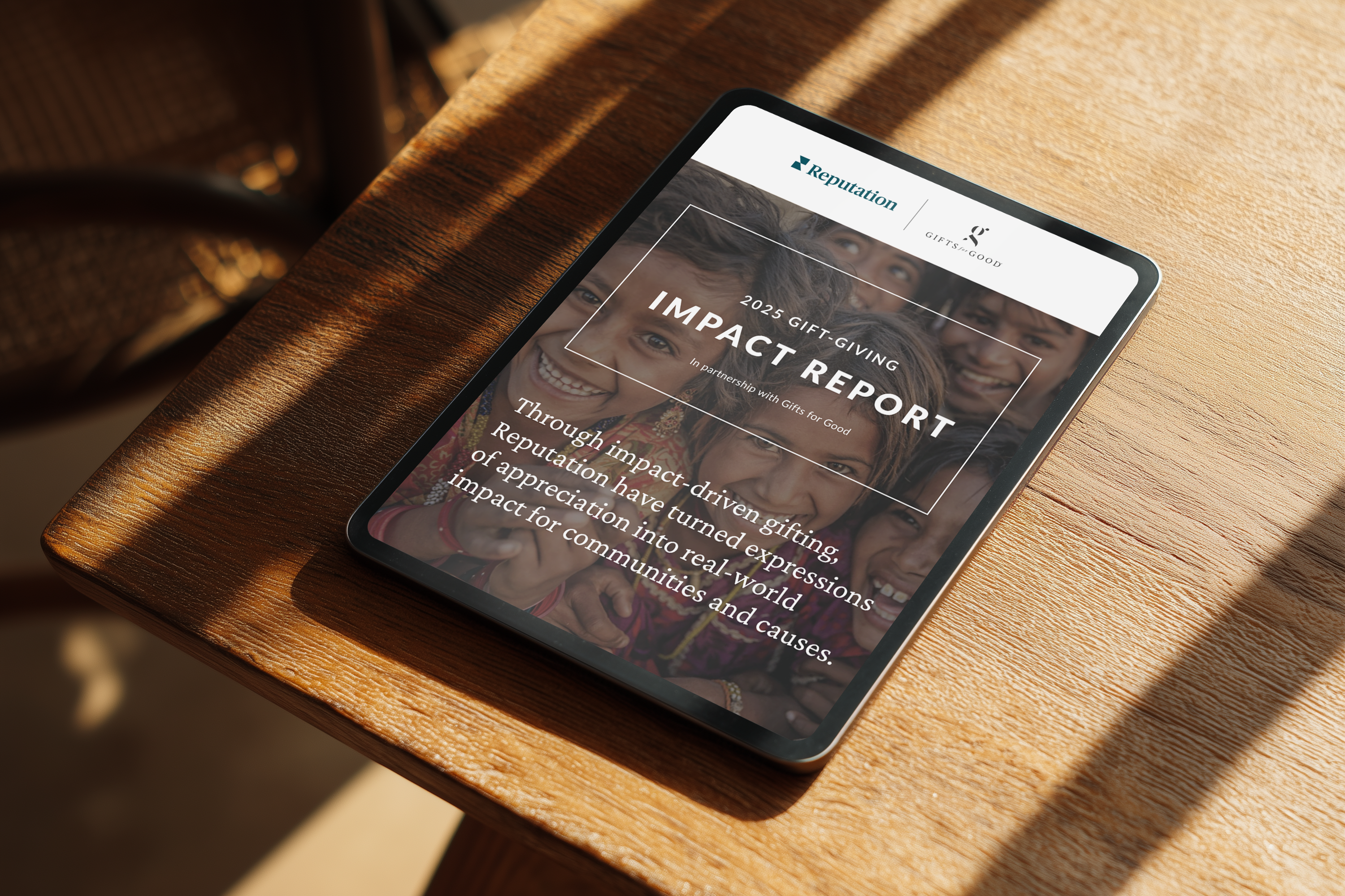 Tablet displaying an impact report on a wooden table.
