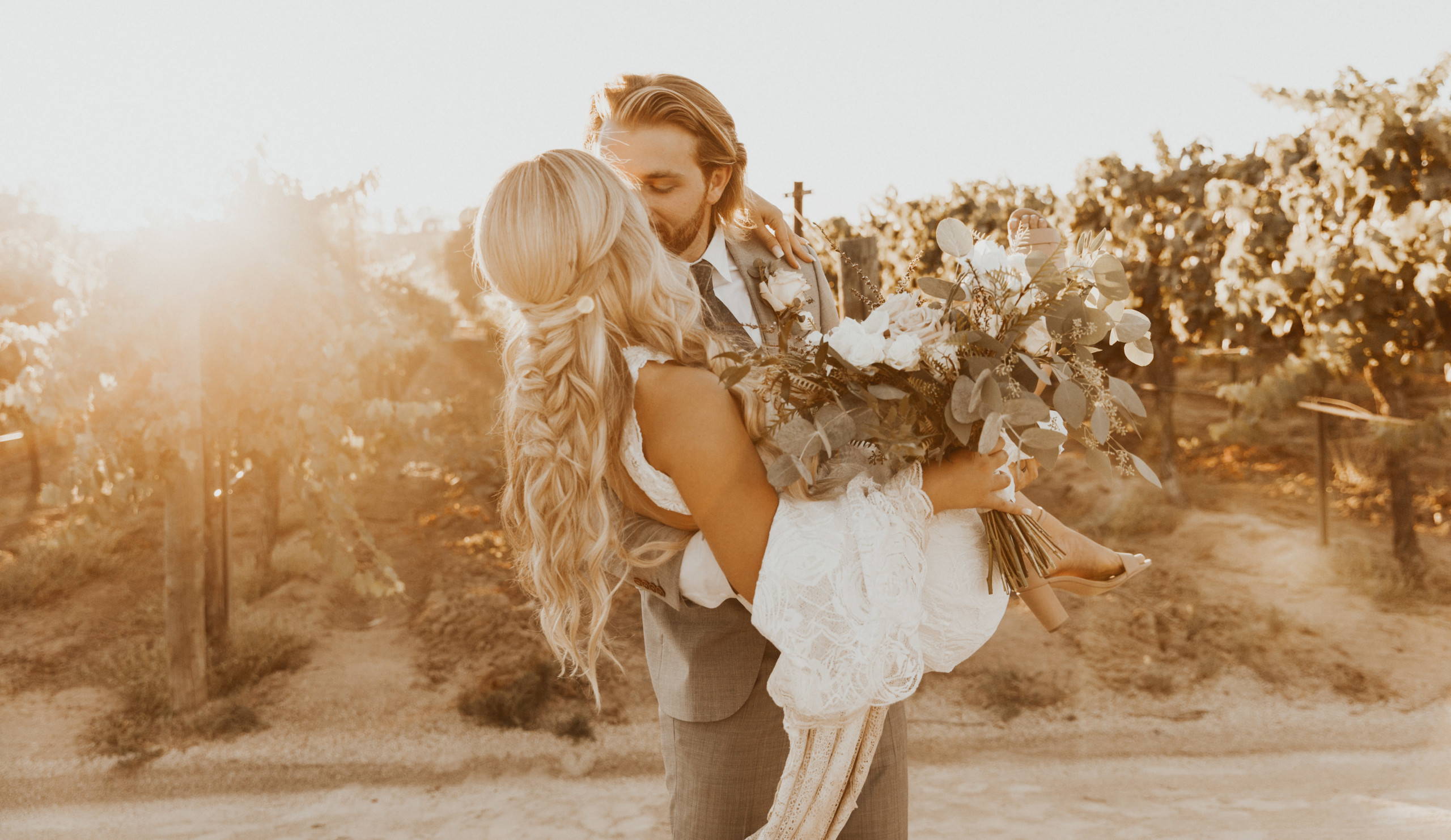 Groom kissing his new wife outdoors