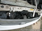 Three black horns mounted behind grille radiator support brackets 2001 Toyota Corolla K5LA train horn gallery photo 5