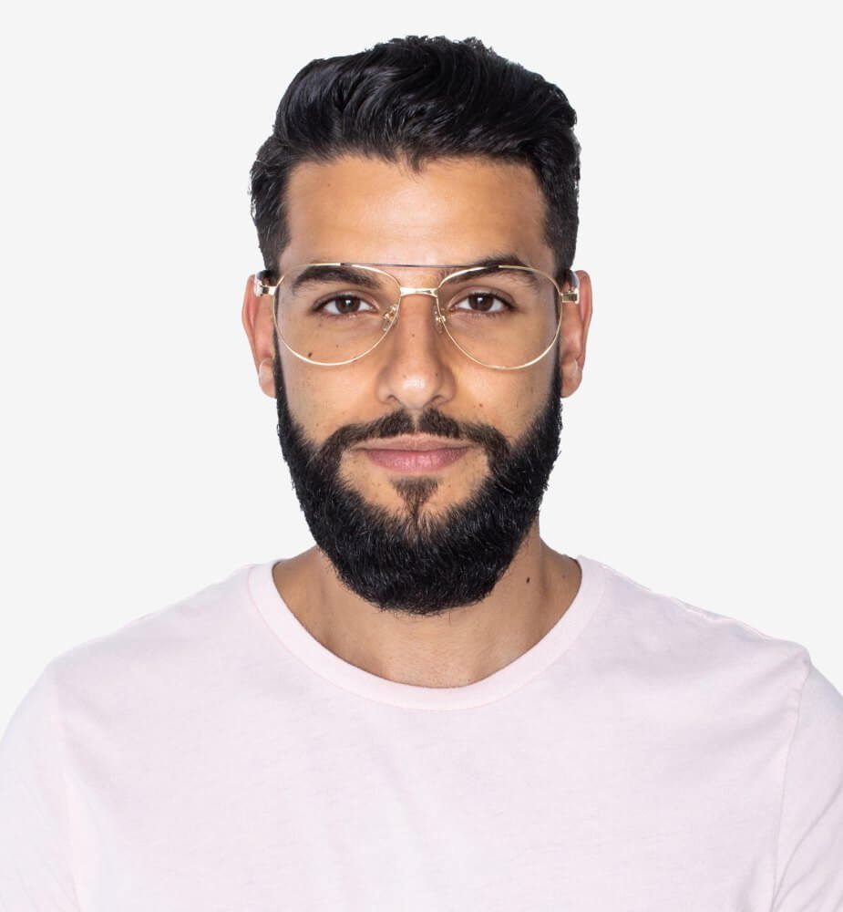 Man wearing Purpose Gold glasses, aviator glasses for diaond face shapes, on a white background