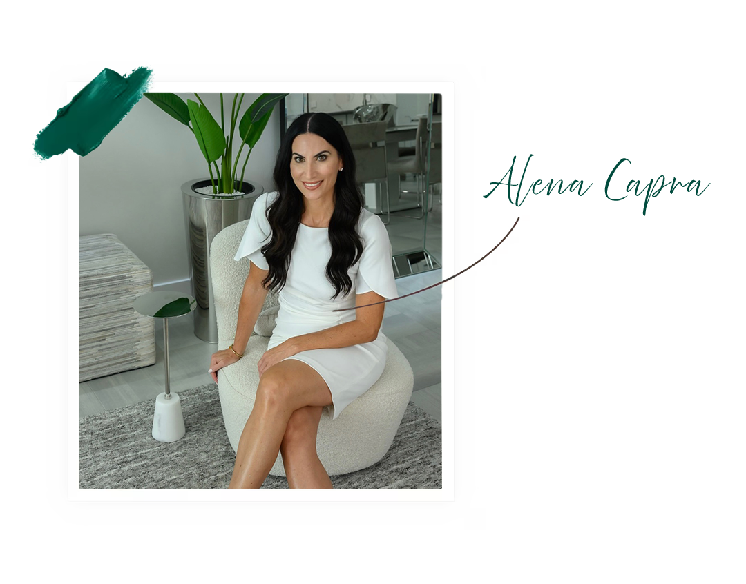 Designer-in-residence Alena Capra sitting in a modern chair, smiling, wearing a white dress.