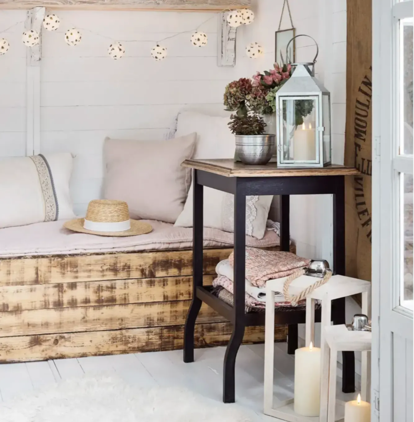 Lanterns and bee fairy lights displayed inside summer house.