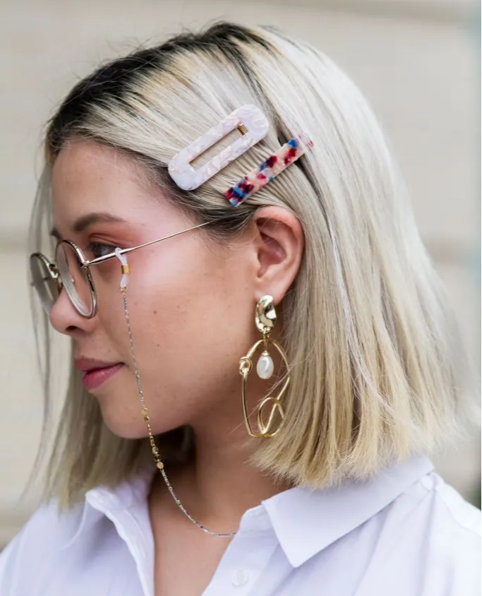 Woman wearing metal glasses chain at NYFW