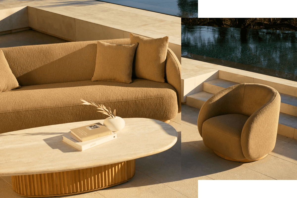 Modern outdoor sofa and lounge chair with textured performance upholstery beside a pool and stone coffee table.