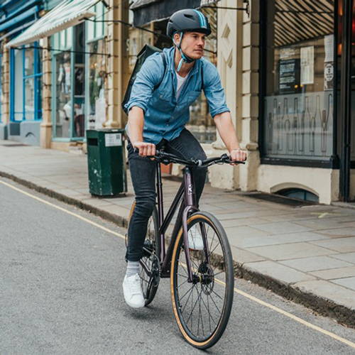 Riding a commuter road-style ebike through the city.