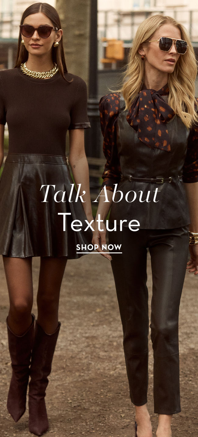 Two models in stylish outfits promoting textured clothing.