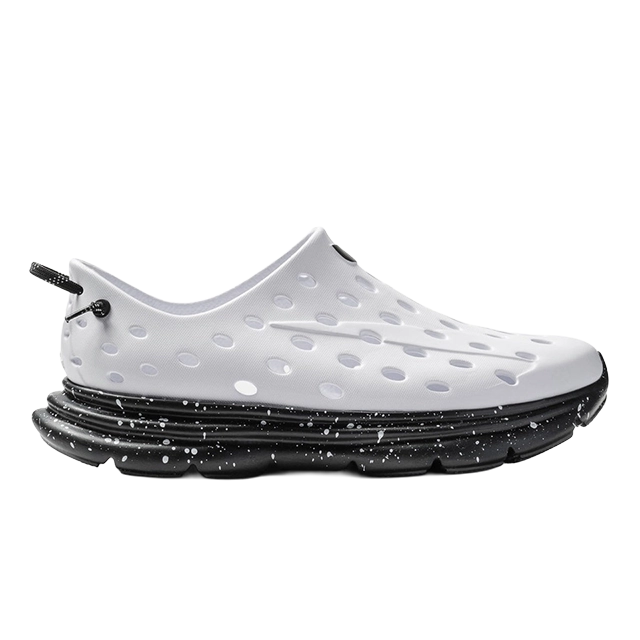 White perforated shoe with a black speckled sole.