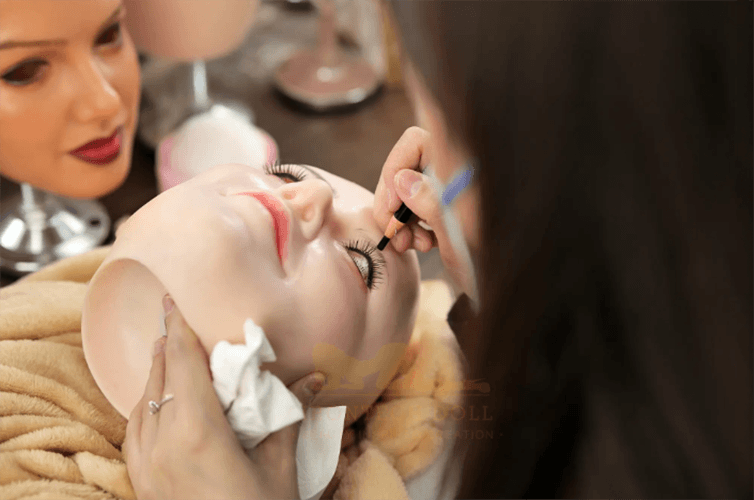 Sex Doll factory picture of employee applying individual eyelashes to a doll's face