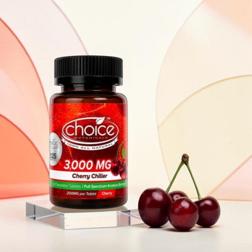 Bottle of cherry-flavored supplement with cherries in front on a colorful background.