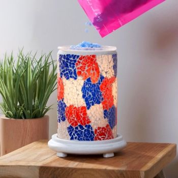Colorful decorative lamp on a wooden table with a small plant.