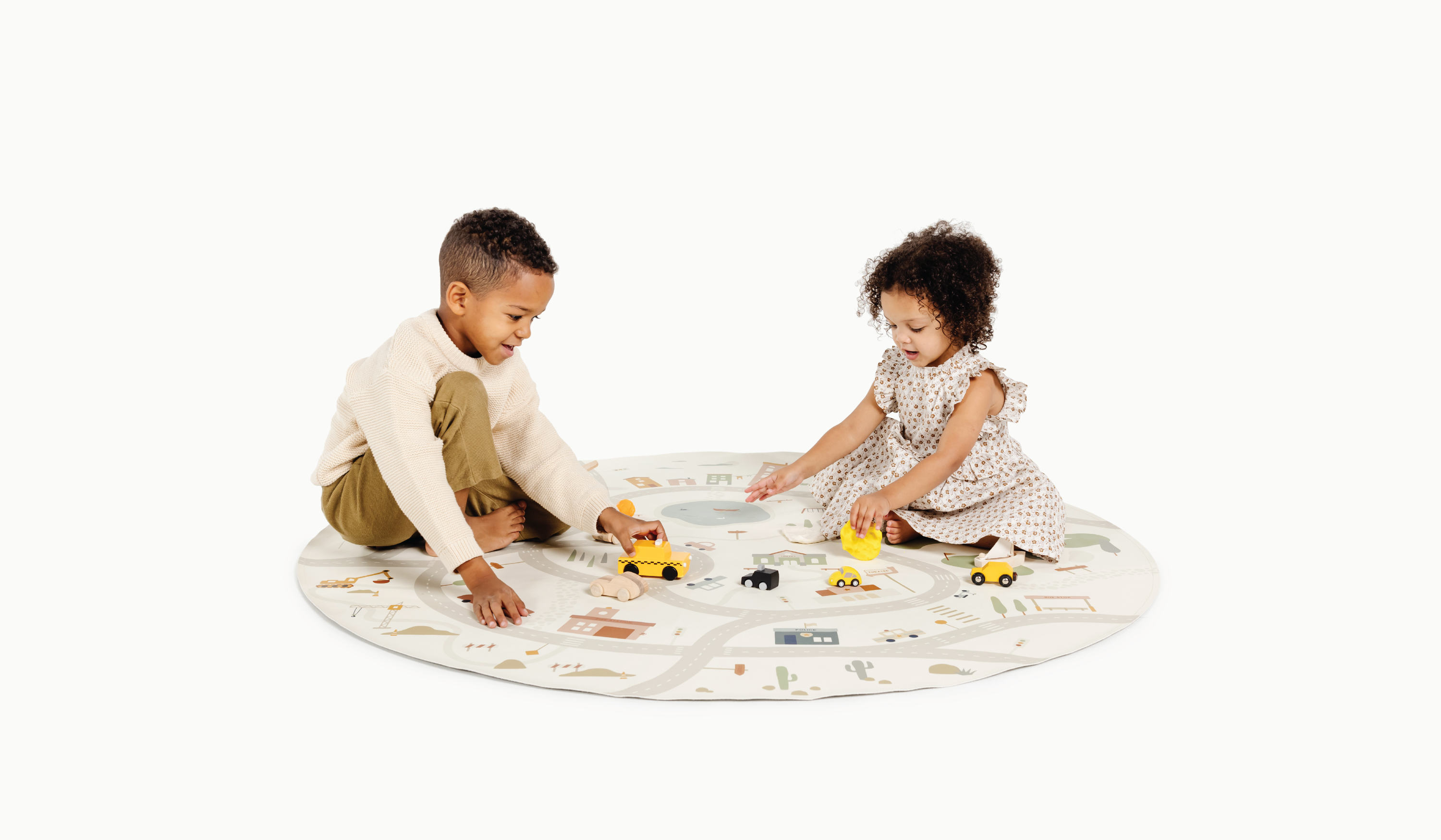 Kids driving toy cars on Gathre Play Mat