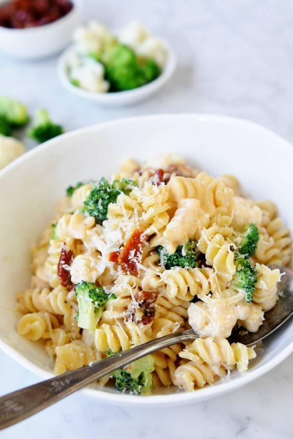 Fusilli pasta with broccoli and cauliflower in a creamy sun-dried tomato sauce