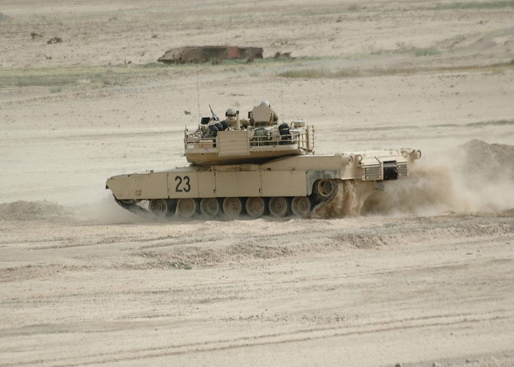 A tank crew of C Company, 1st Battalion, 13th Armored Regiment quickly maneuvers their M1 Abrams Tank to the next firing point during a qualification run. C Company recently underwent semi-annual qualification at Butler Range in Iraq during Operation Iraqi Freedom III.