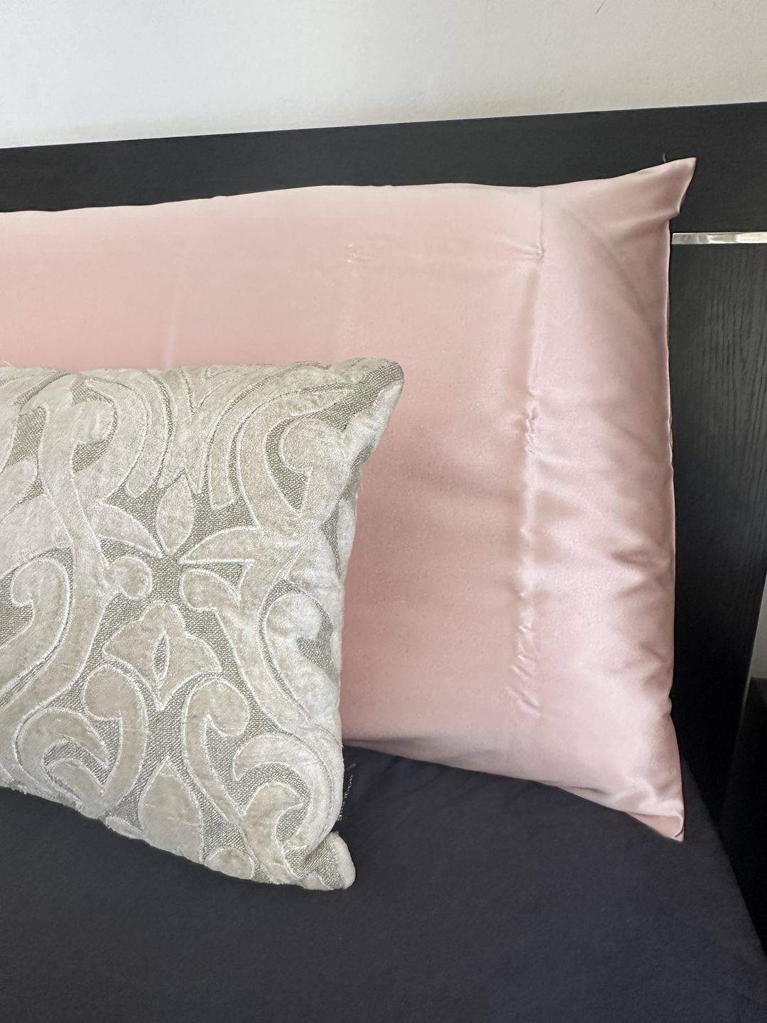 pink pillowcase with grey cushion in front