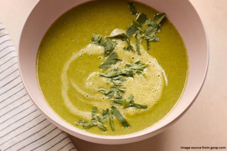 green soup in a light pink bowl