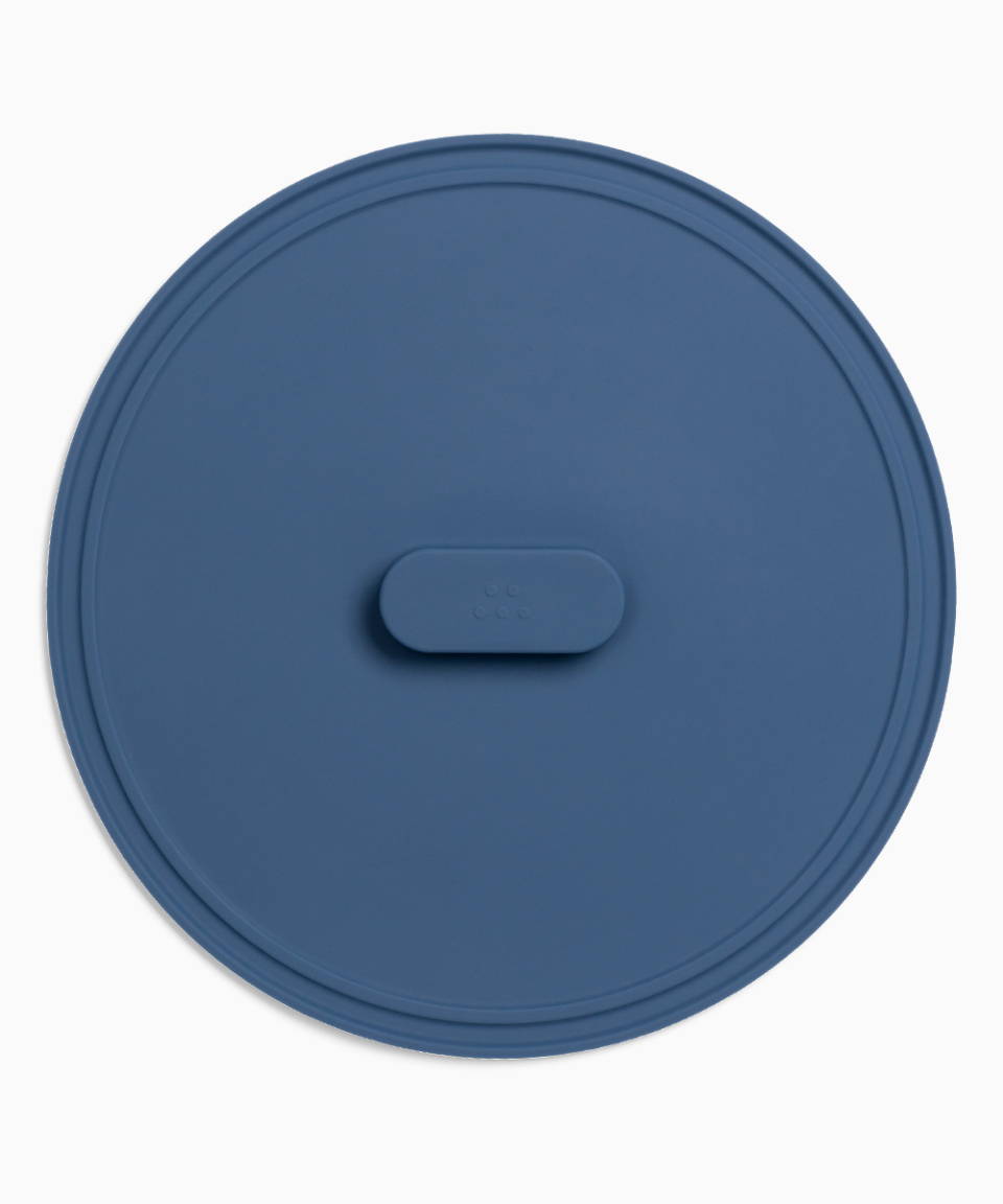 A Blue Misen Universal Lid seen from directly above, with raised central handle visible.
