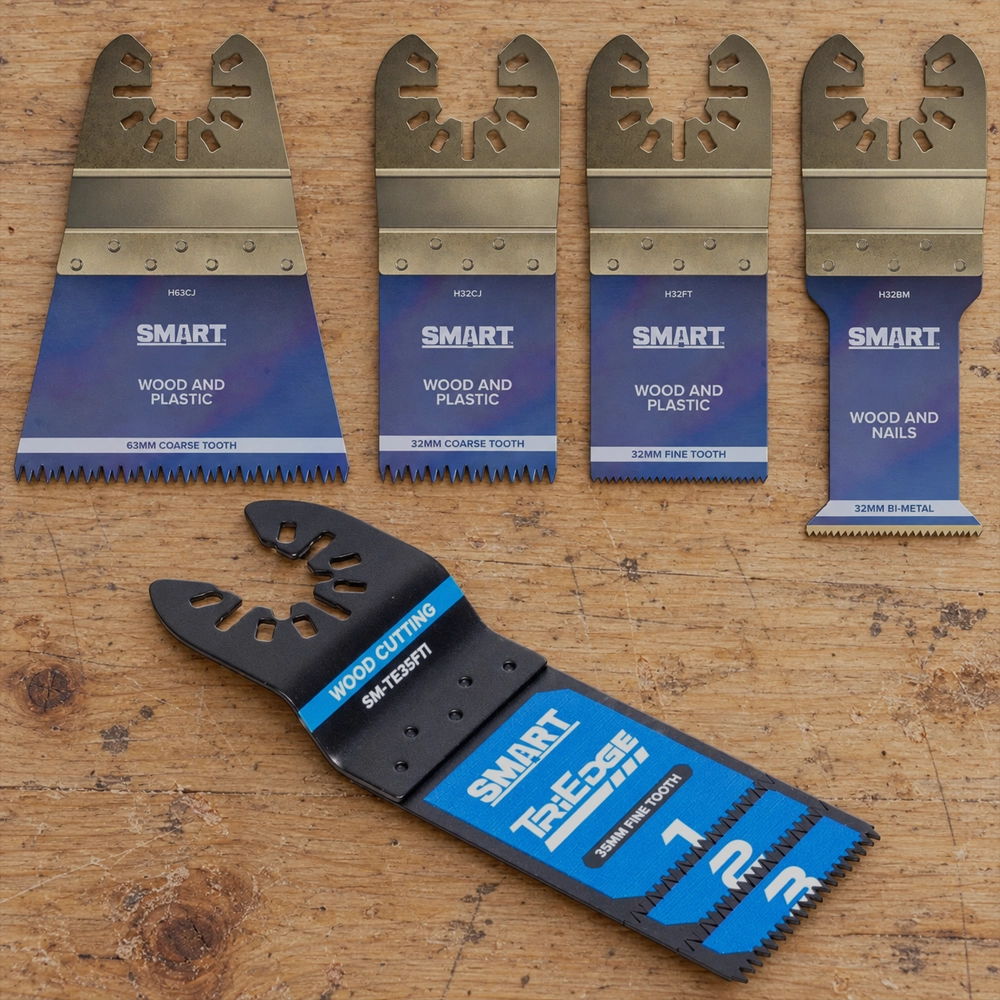 Four multi-tools with a blue and gold design on a wooden surface.