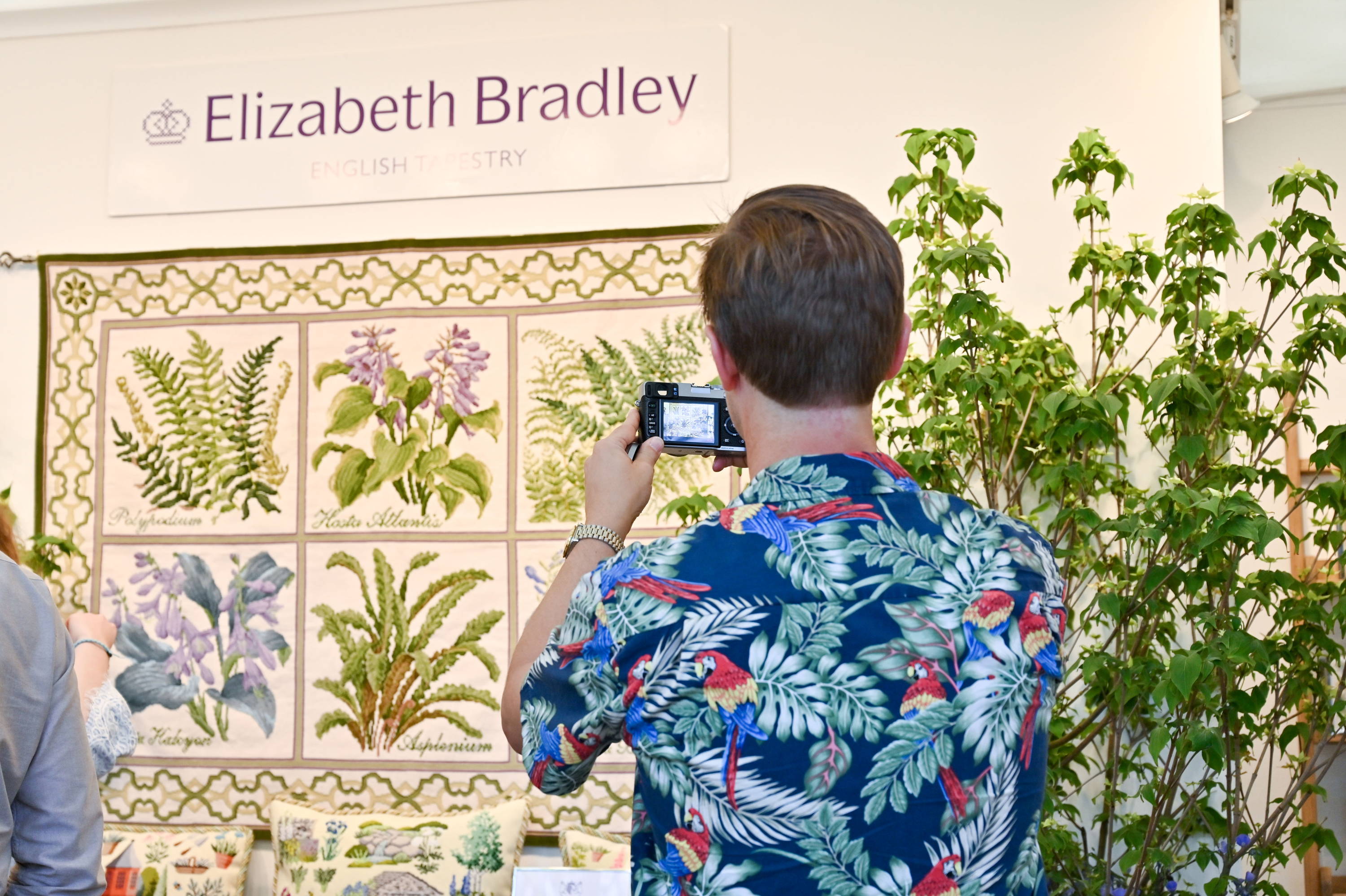 Customer photographing the Shade Garden tapestry