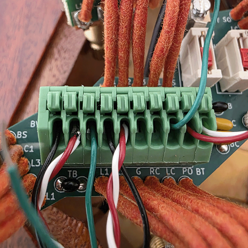 Close-up of a green terminal block with connected wires.