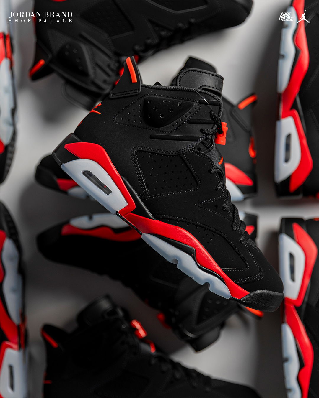 A collection of black and red Air Jordan 6 sneakers arranged artistically.