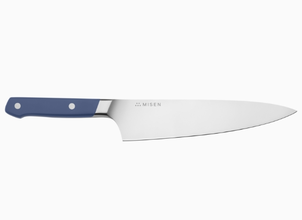 A blue Misen Chef’s Knife seen from the side, with the Misen logo visible at the base of the knife’s spine.