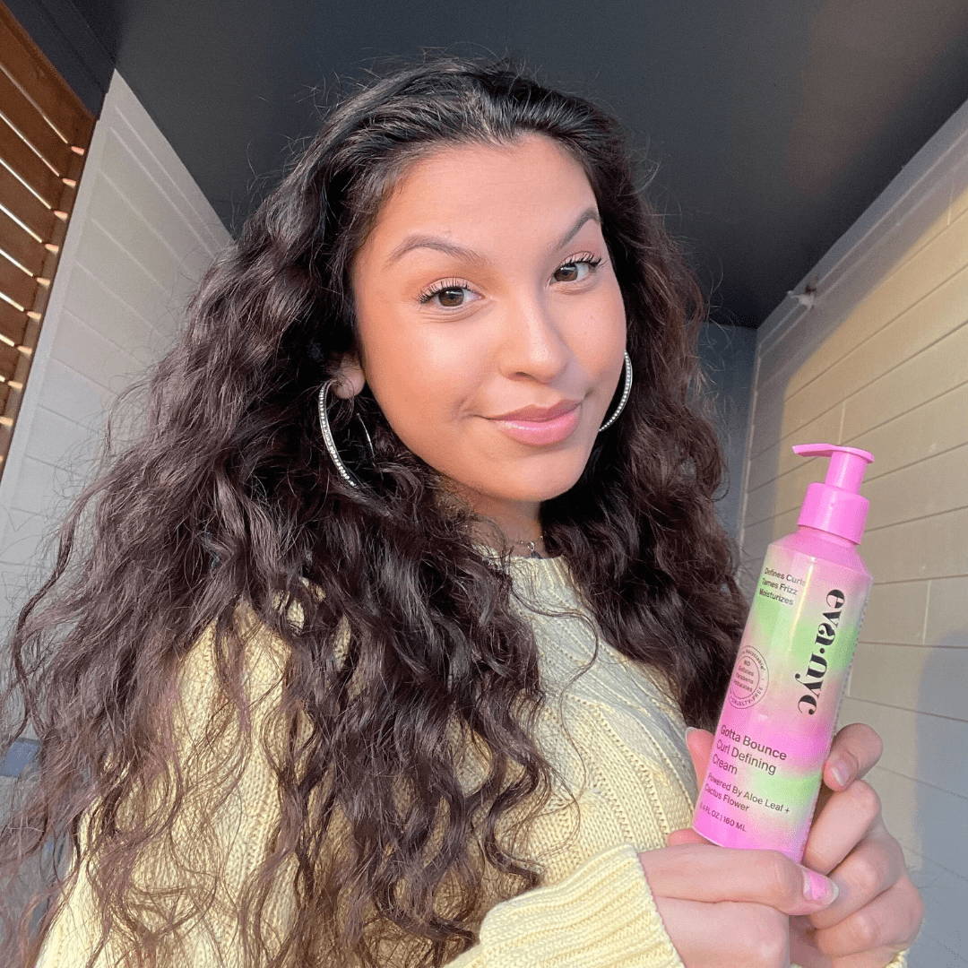 Eva NYC Campus Mane Ambassador holding Eva NYC's Gotta Bounce Curl Defining Cream