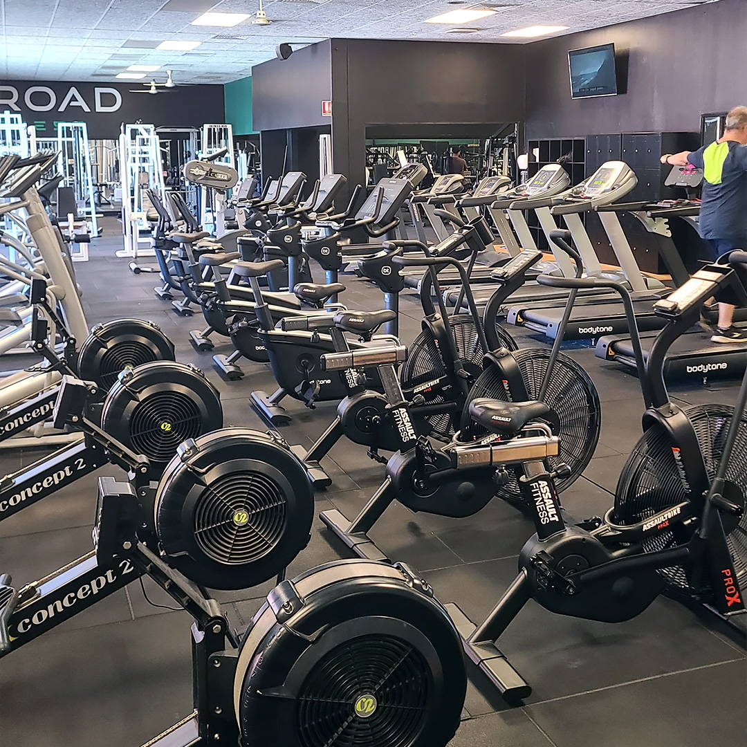 State-of-the-art Gym Fit Out: A broad selection of stationary bikes and rowing machines in a sleek fitness center.