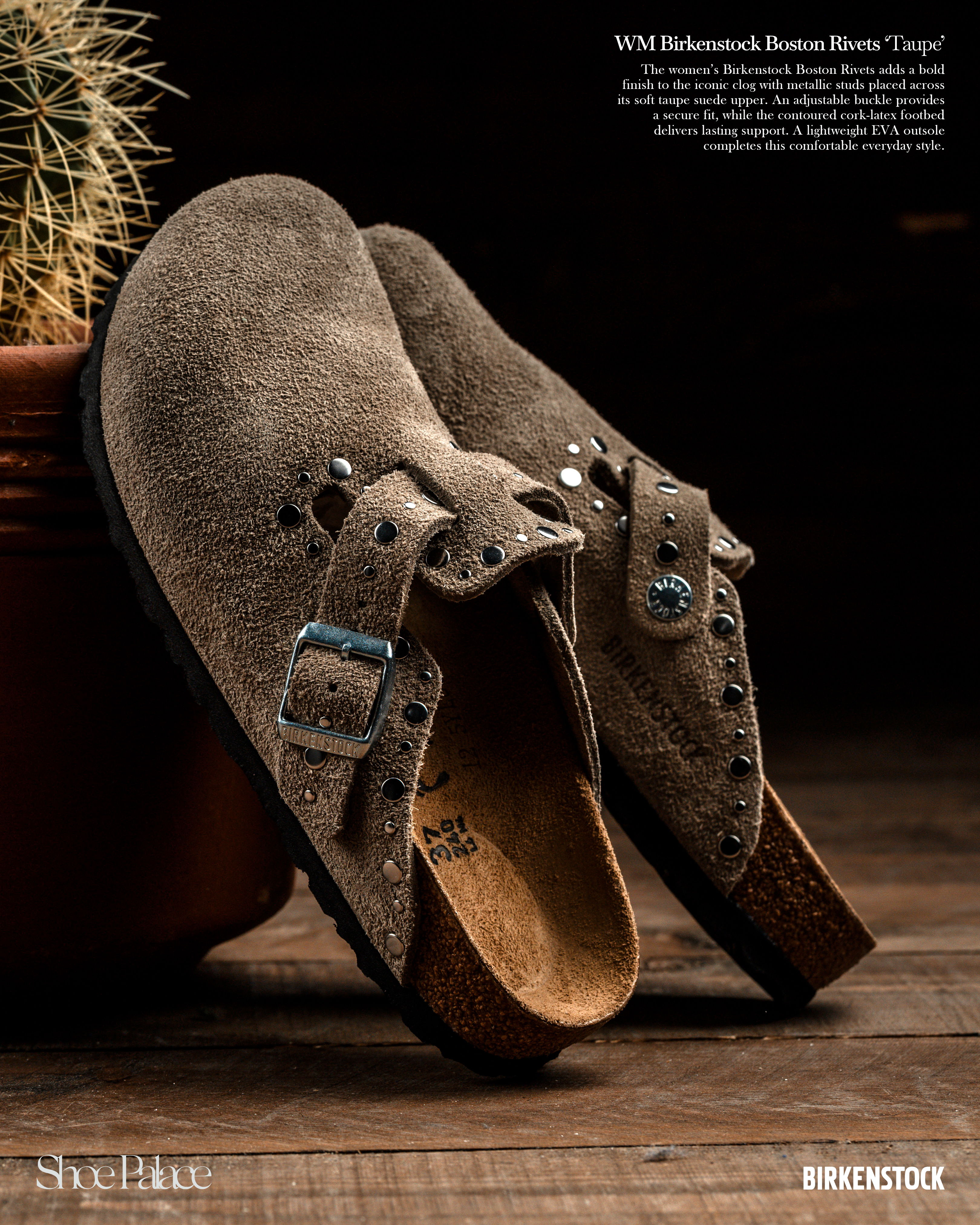 Brown suede clogs with buckles on a wooden surface near a plant.