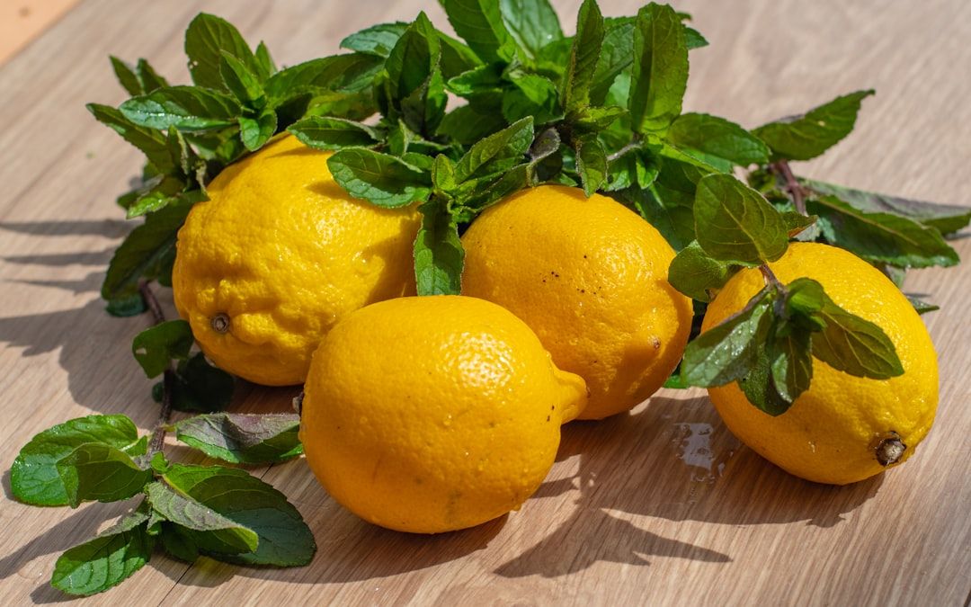 a group of lemons sitting on top of a wooden table