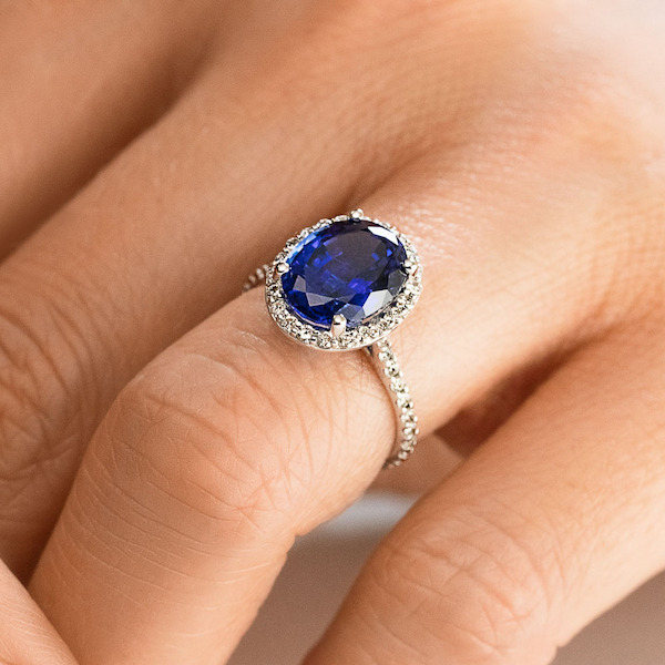 Diamond accented halo engagement ring with 2ct oval lab grown blue sapphire in 14k white gold
