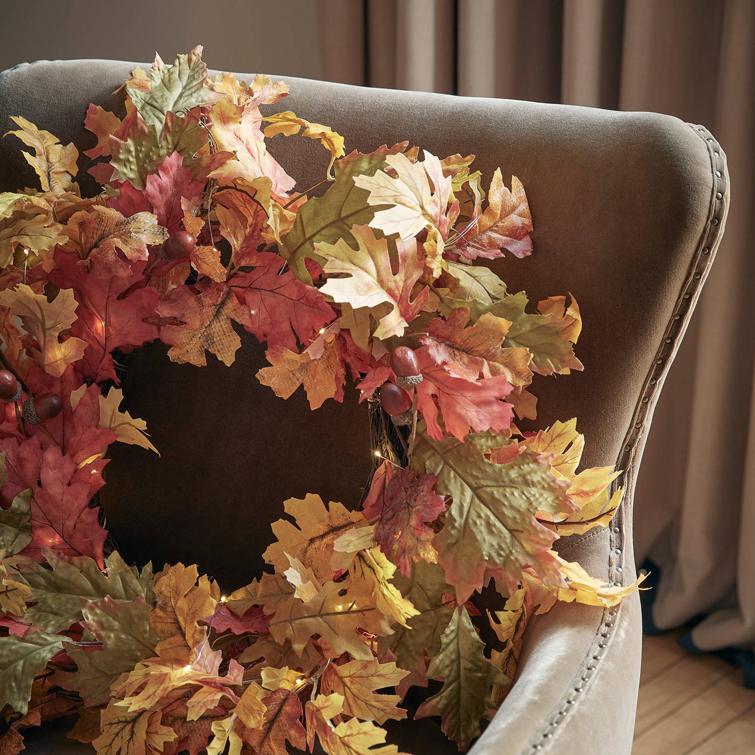 Oak leaf autumn wreath on a cosy chair