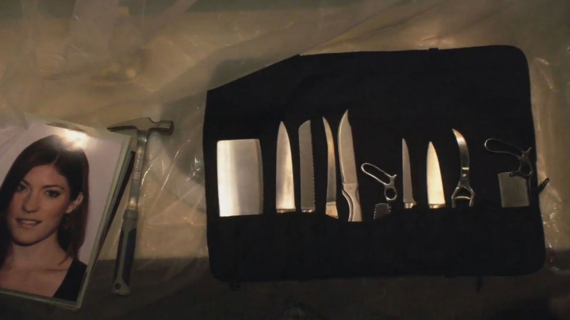 A set of knives next to a photo of a woman.