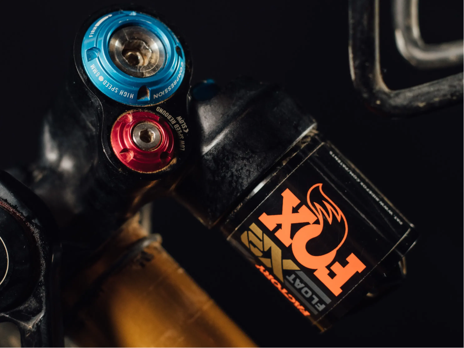2022 Fox Float X2 on a black background detail of rebound knob ompression knob and piggy back 