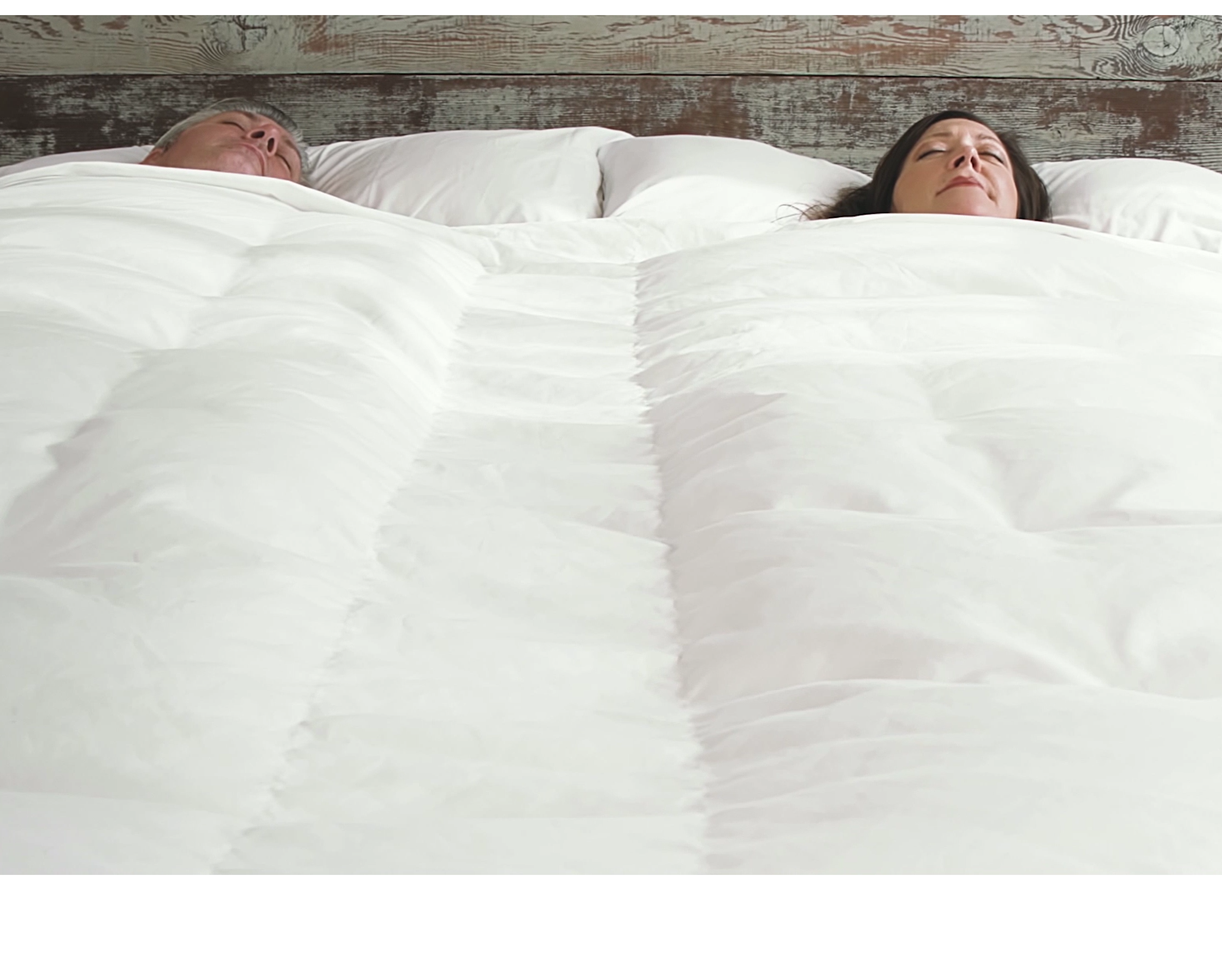A couple sleeping peacefully under a BedJet Cloud Sheet